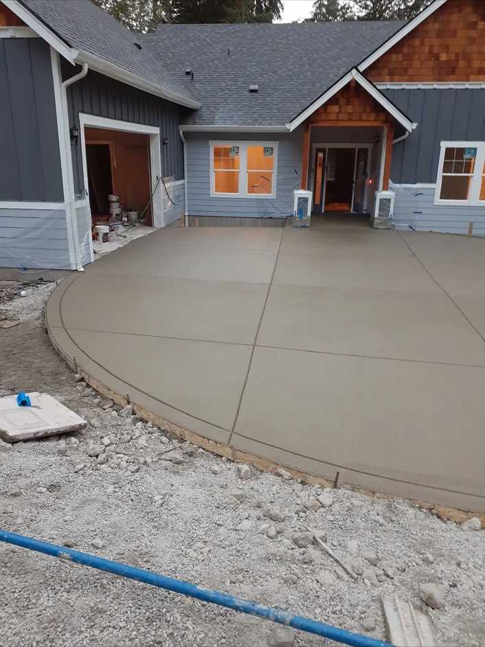 Broad concrete patio with a curved outer edge